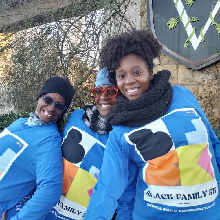 Our family smiling together in matching blue 5K shirts